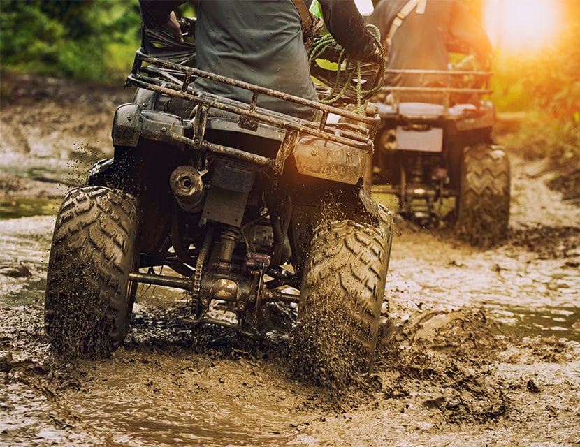 ATVs driving in the mud